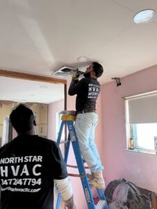 HVAC technician installing air conditioner in NYC home