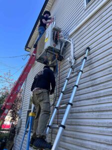 HVAC technician repairing air conditioner in Long Island NY